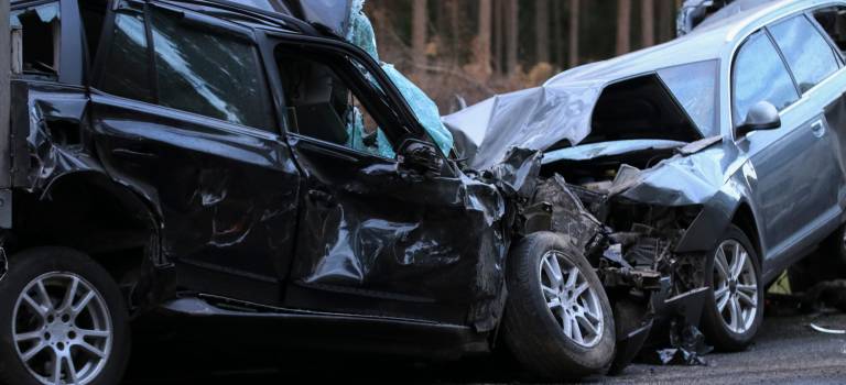 two totaled cars in head on collision